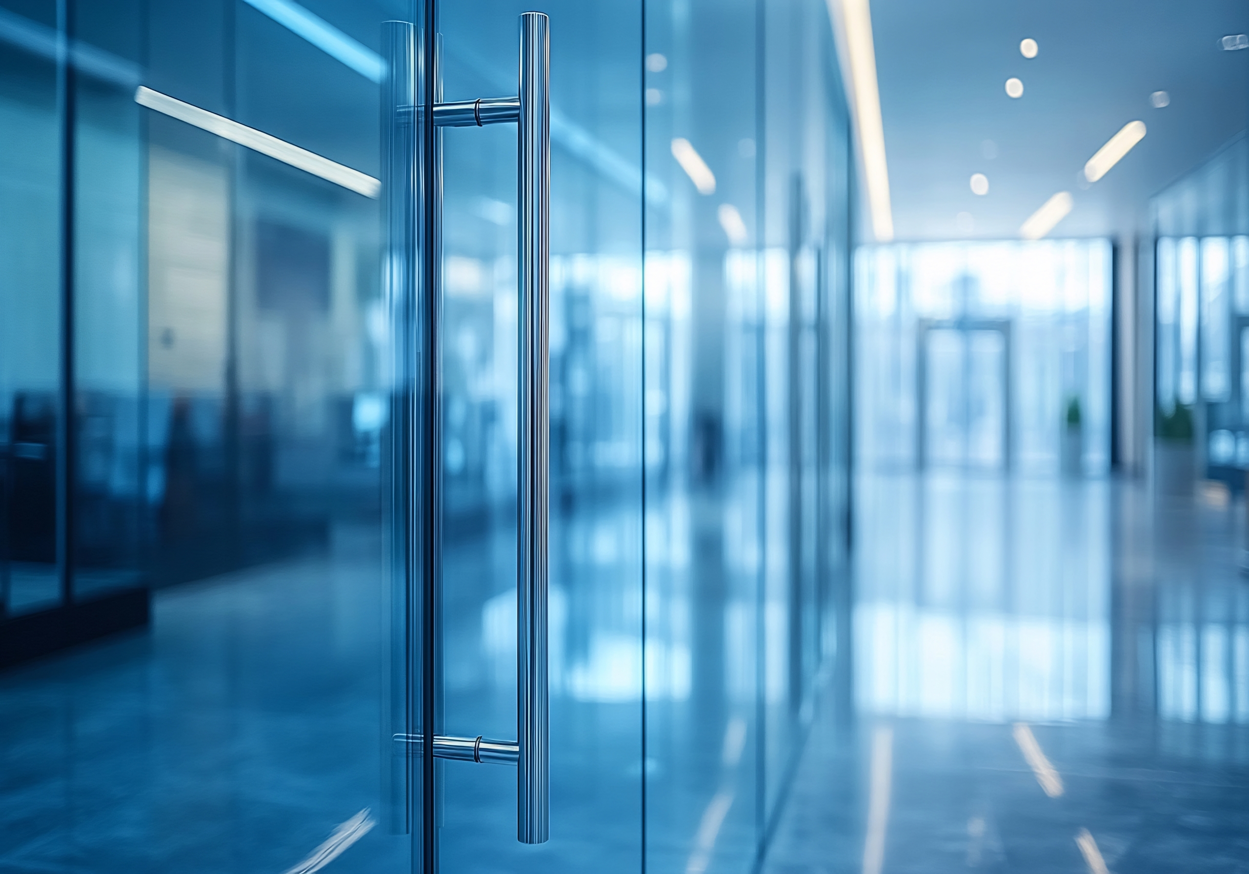 modern office interior: glass doors and polished steel handle